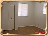 Bedroom 1 (of 2) features a roomy closet, three windows, and easy-to-maintain vinyl plank flooring.